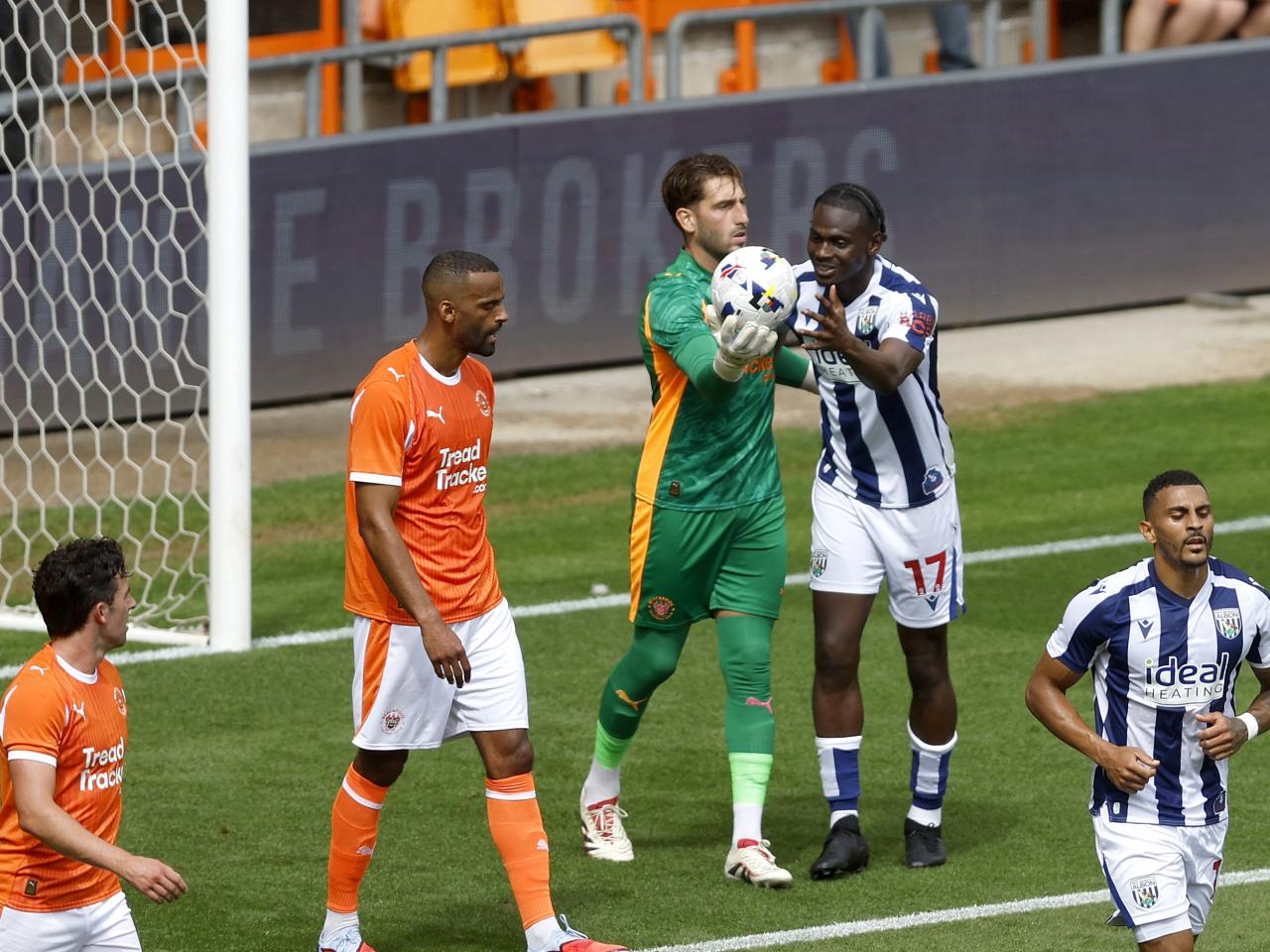 Ousmane Diakité trying to get the ball off the Blackpool goalkeeper
