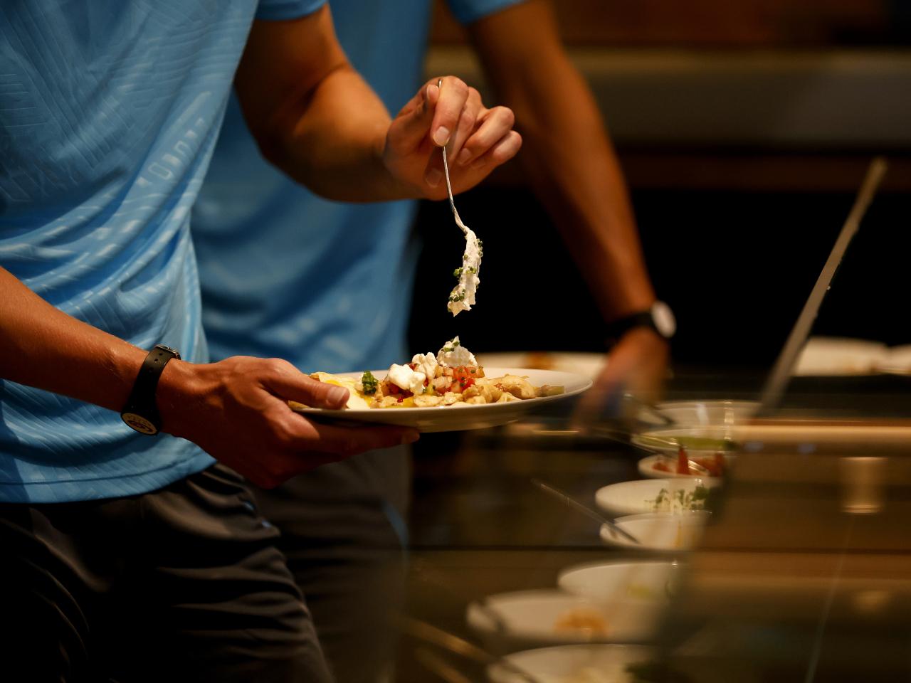 A player placing food on his plate 