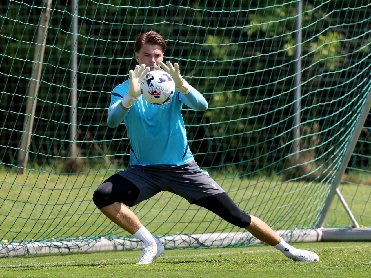Josh Griffiths saving a shot during a training session