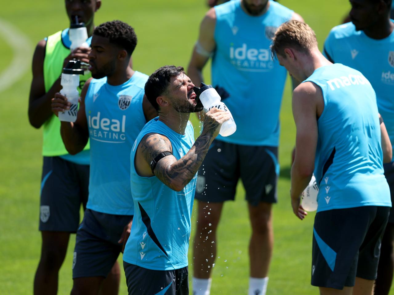 Alex Mowatt and Darnell Furlong drinking water during a training session