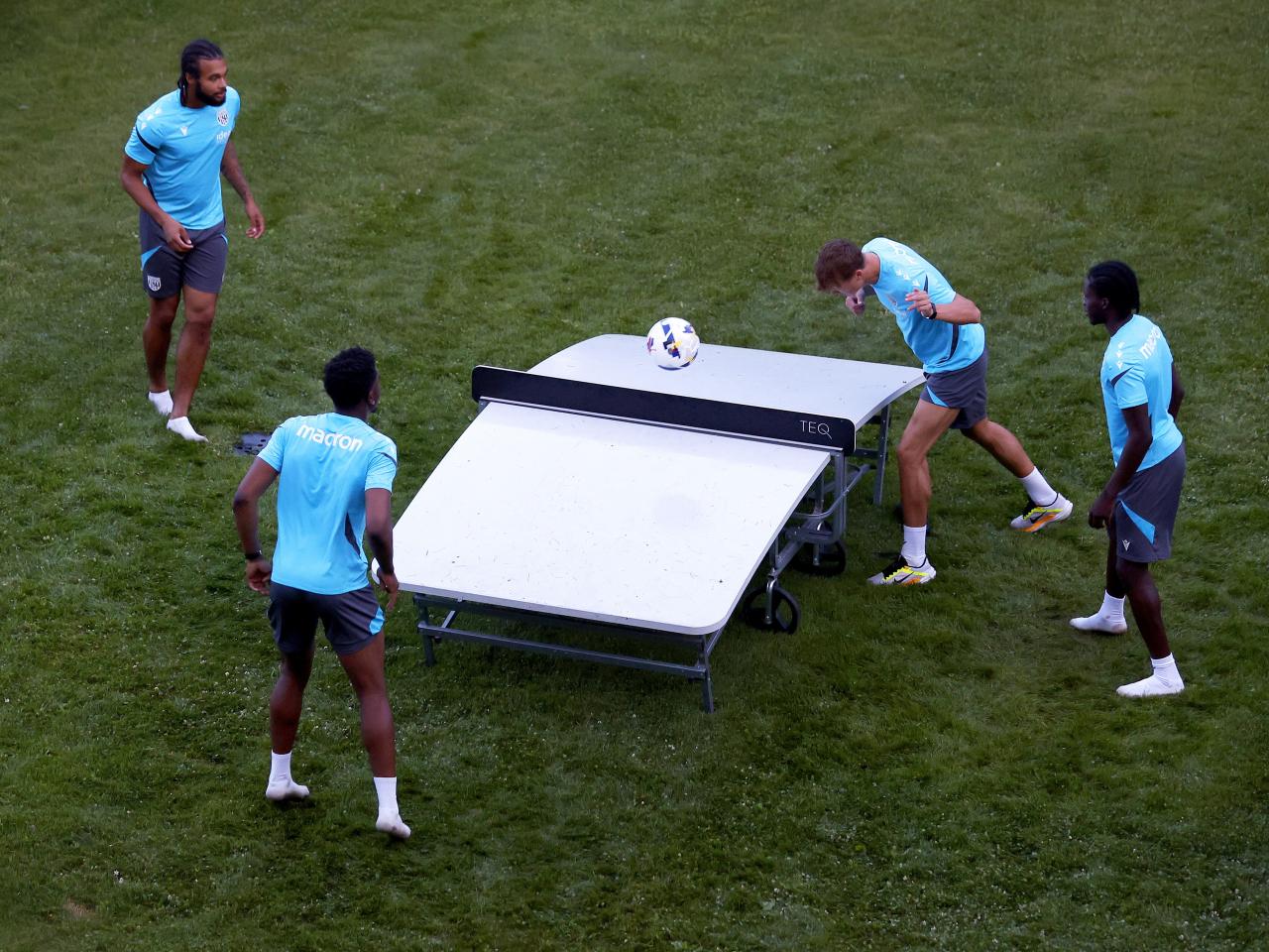 Four young players playing football tennis 