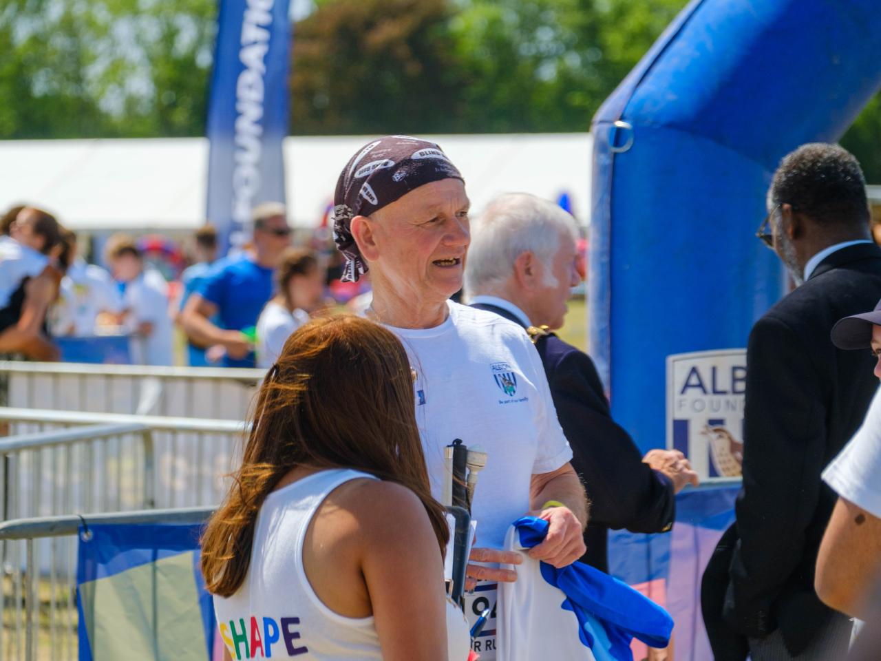 Blind Dave in conversation with a SHAPE festival staff member.