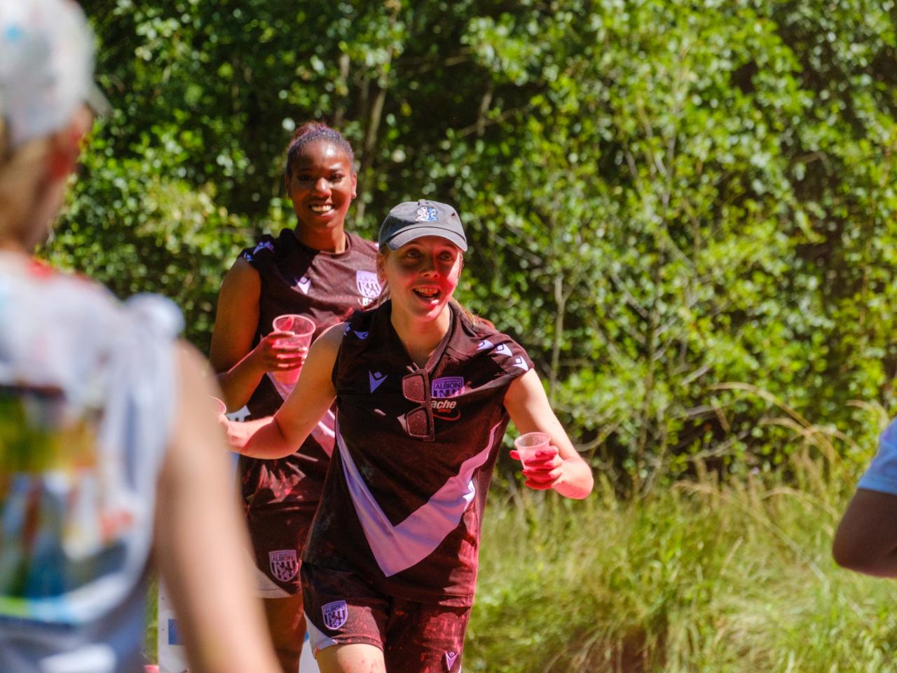 Close up of Foundation staff members with cups of paint powder.