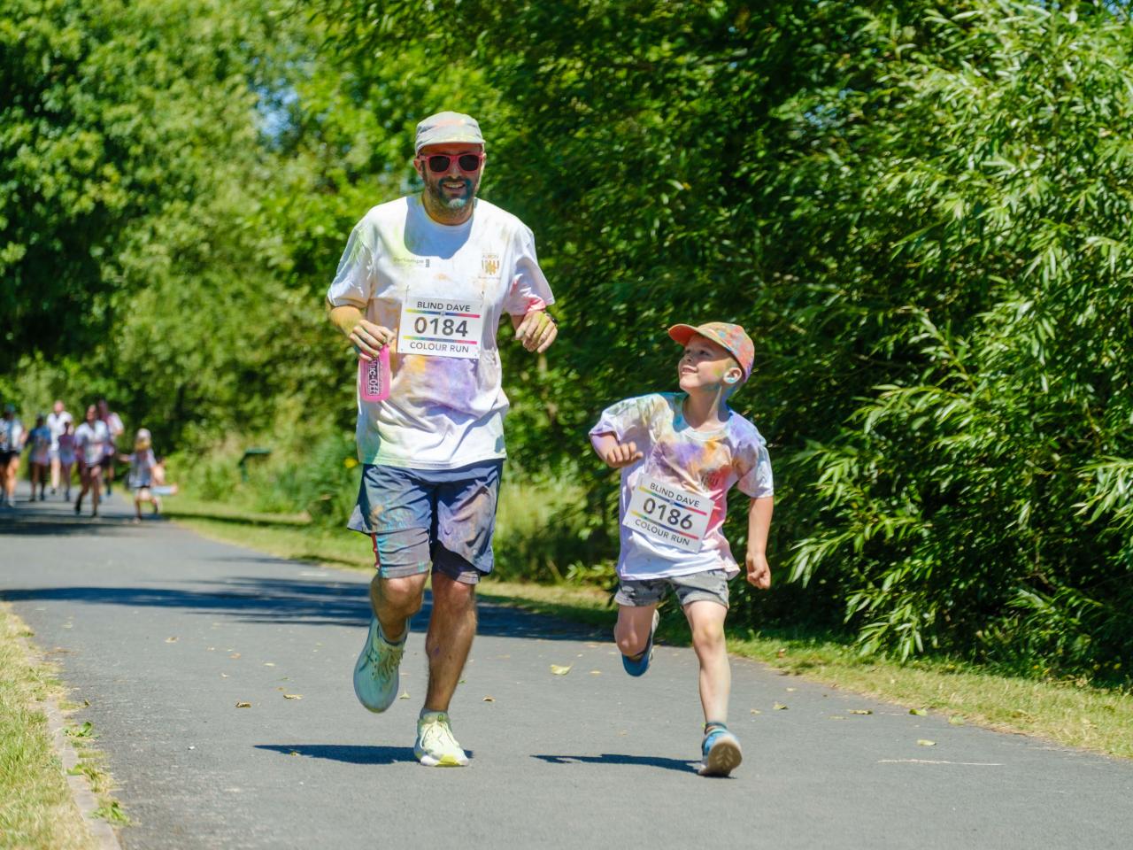 Father and son running on the path.