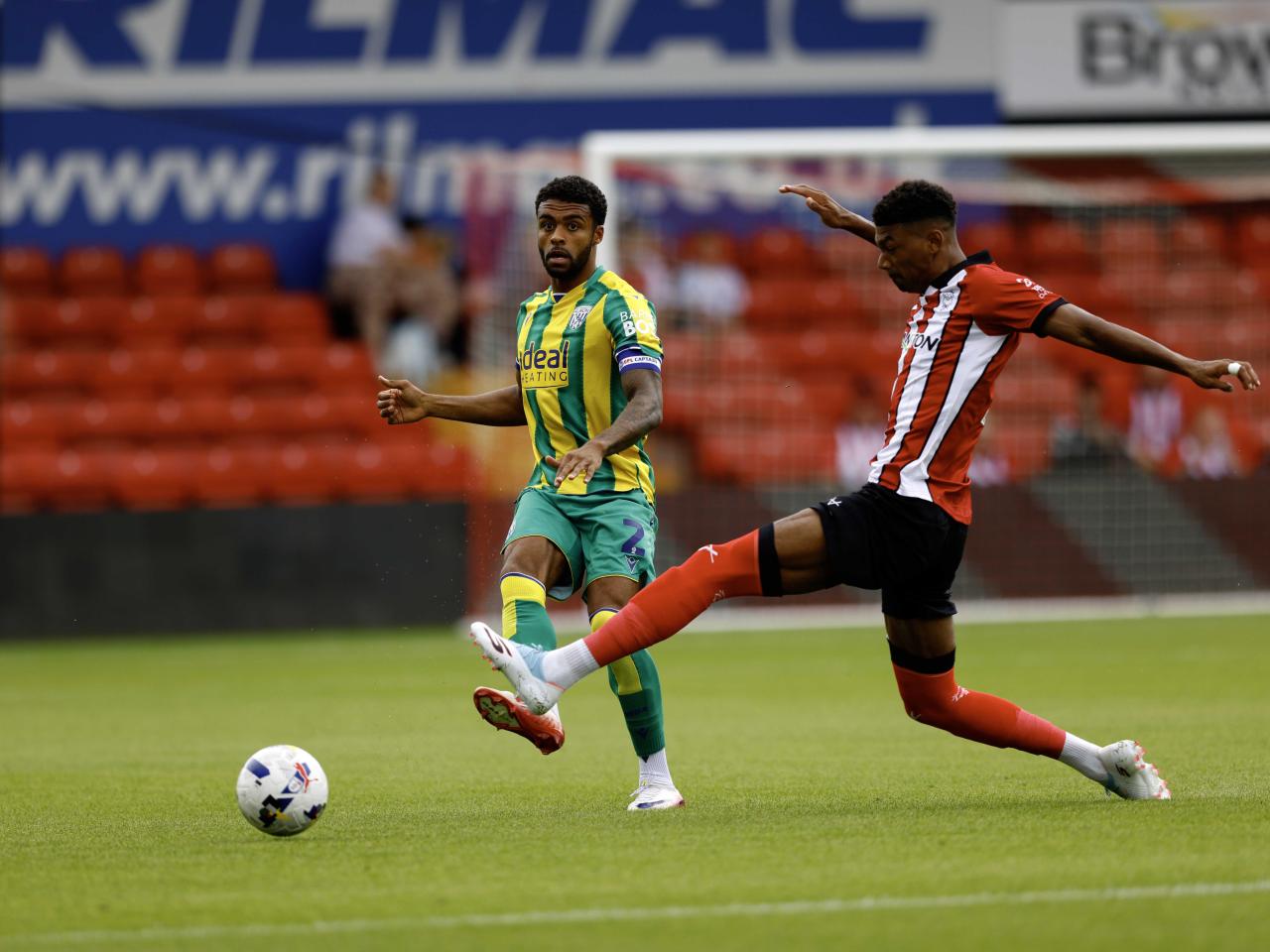 A photo of Darnell Furlong in the 2025/26 green and yellow away kit