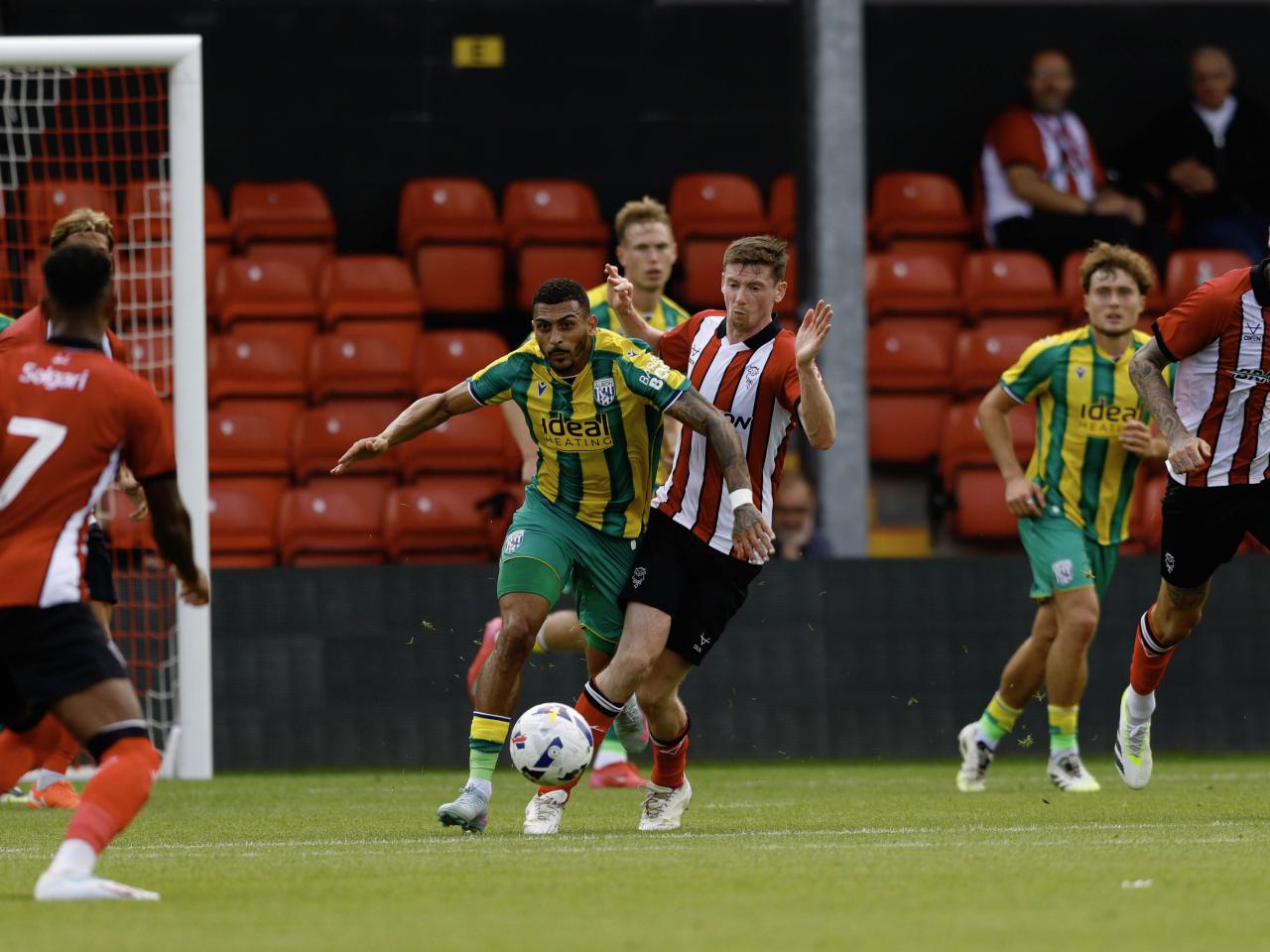 A photo of Karlan Grant in the 2025/26 green and yellow away kit