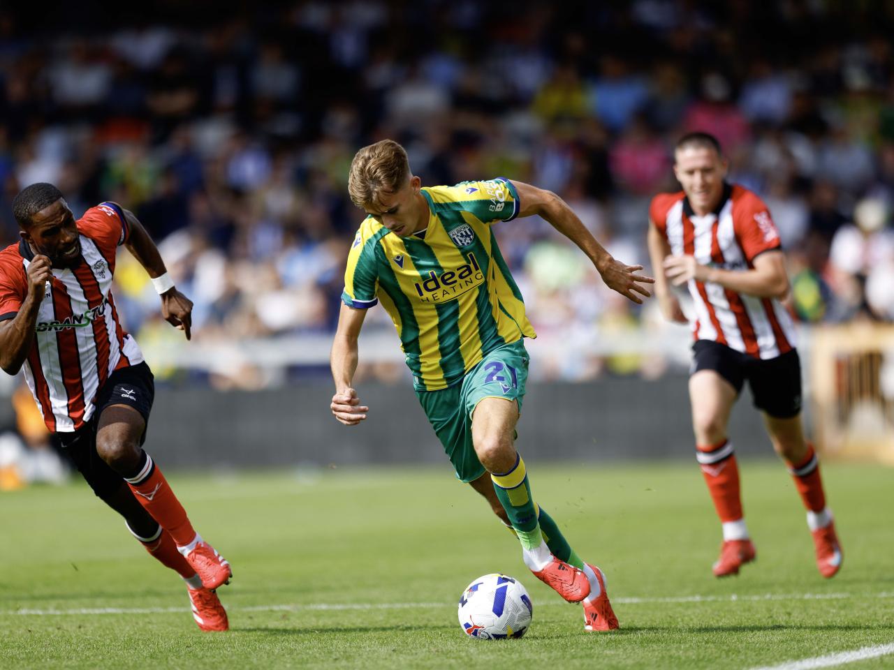 A photo of George Campbell in the 2025/26 green and yellow away kit