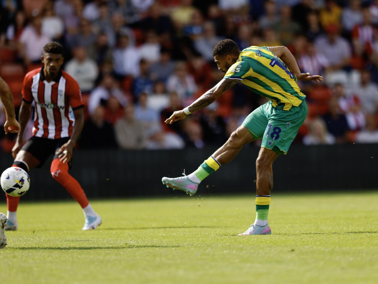 A photo of Karlan Grant in the 2025/26 green and yellow away kit