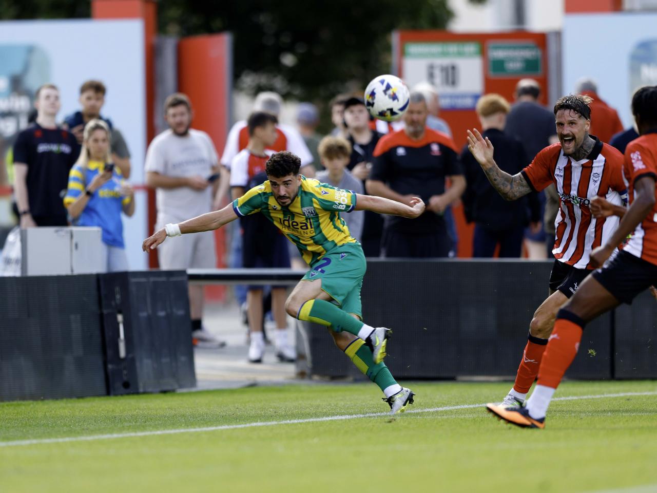 A photo of Mikey Johnston in the 2025/26 green and yellow away kit