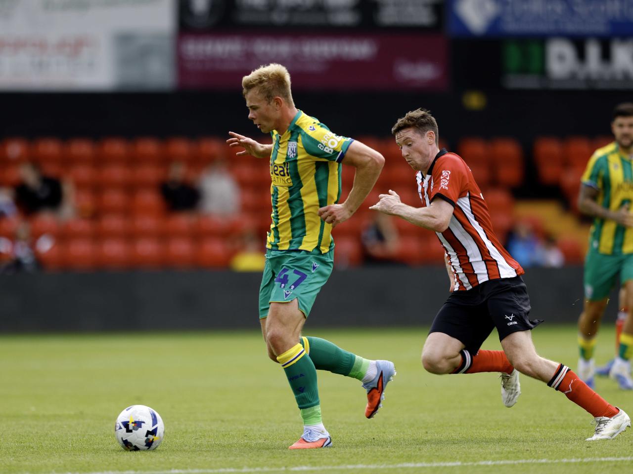 A photo of Aune Heggebo in the 2025/26 green and yellow away kit