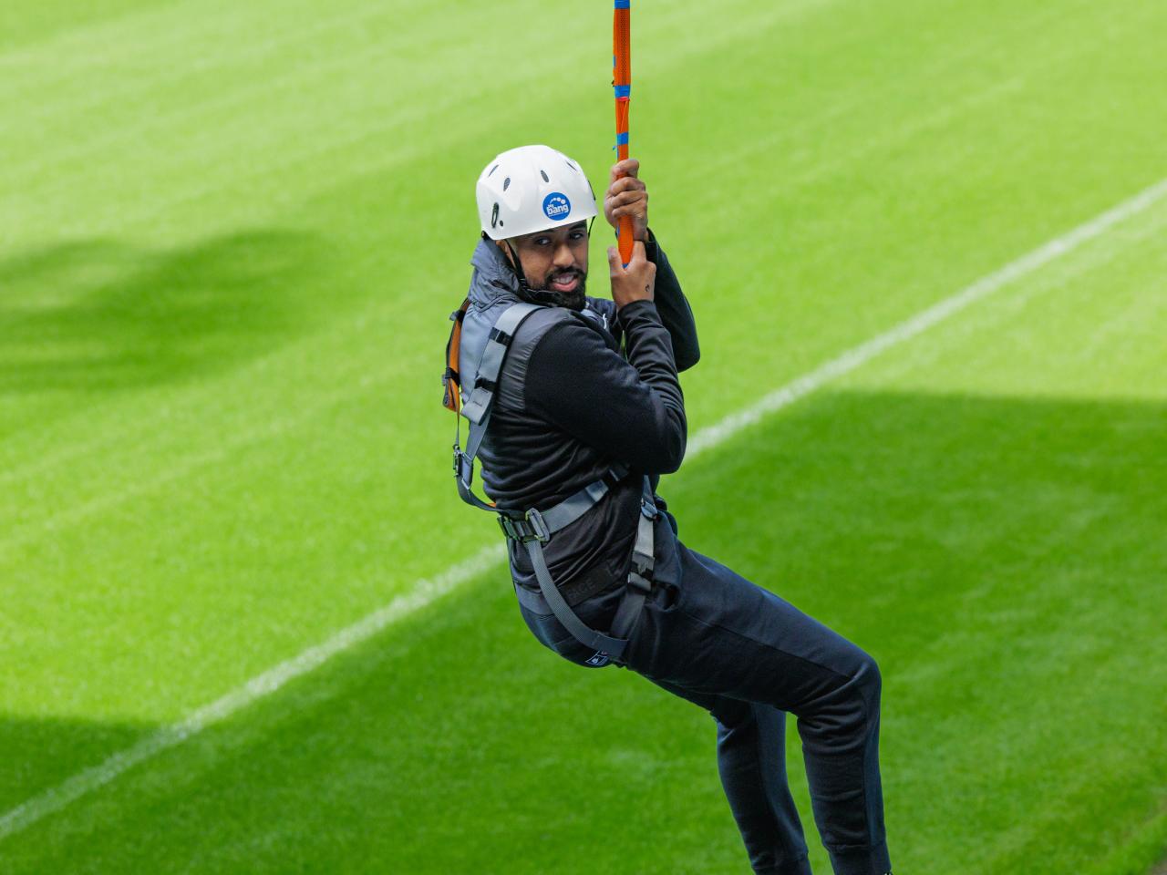 A participant zip wires across The Hawthorns.