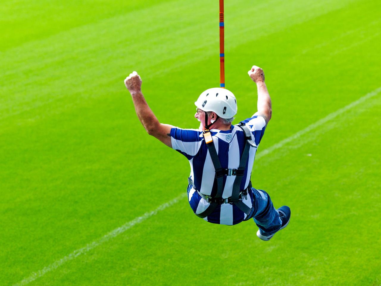 A participant zip wires across The Hawthorns.