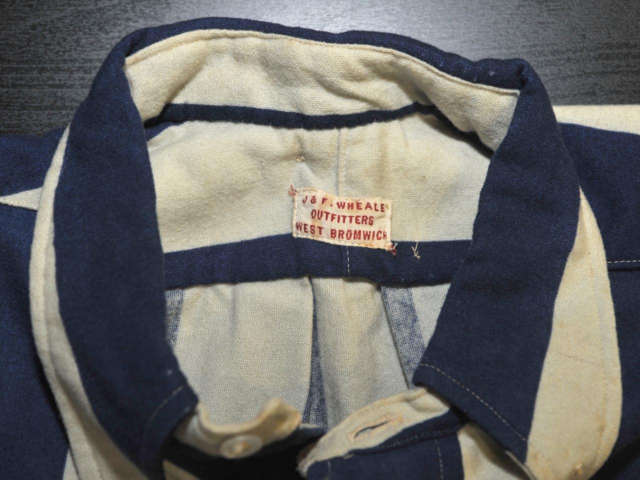 Close up of shirt label featuring J&F Wheale Outfitters West Bromwich 