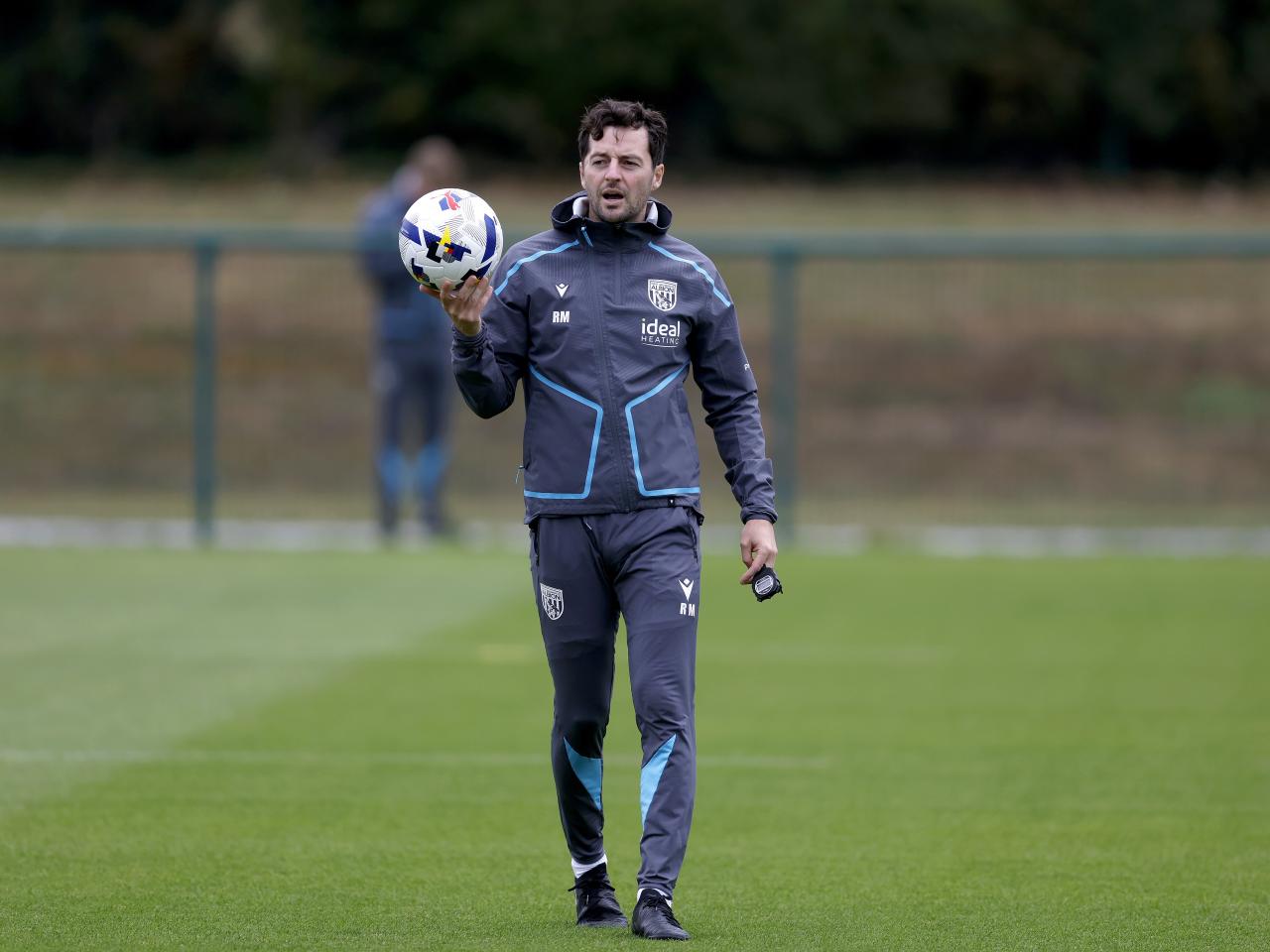 Ryan Mason holding a ball during a training session 