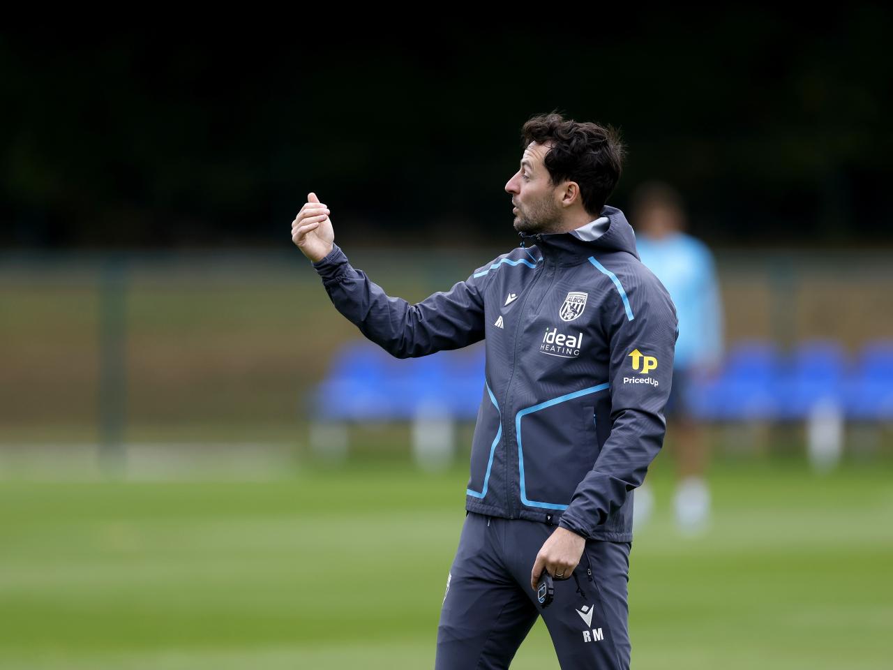 Ryan Mason delivering instructions to his players during a training session