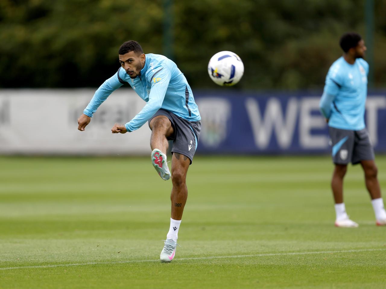 Karlan Grant striking the ball during training 