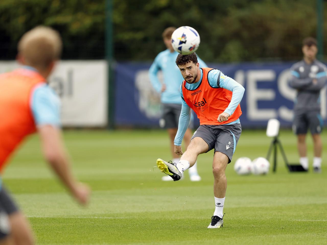 Mikey Johnston striking the ball during training 