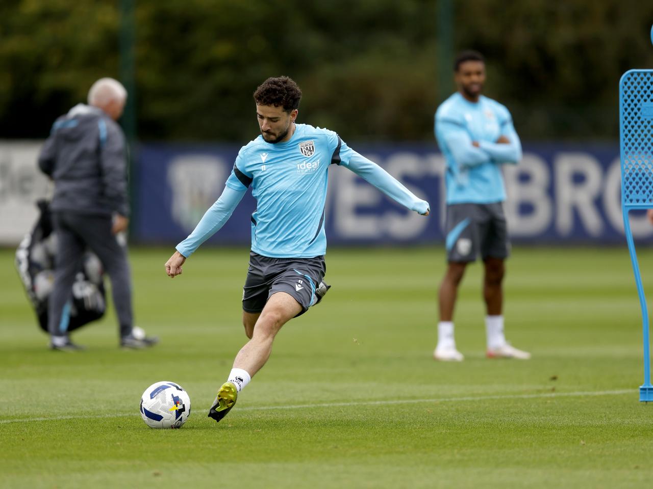 Mikey Johnston striking the ball during training 