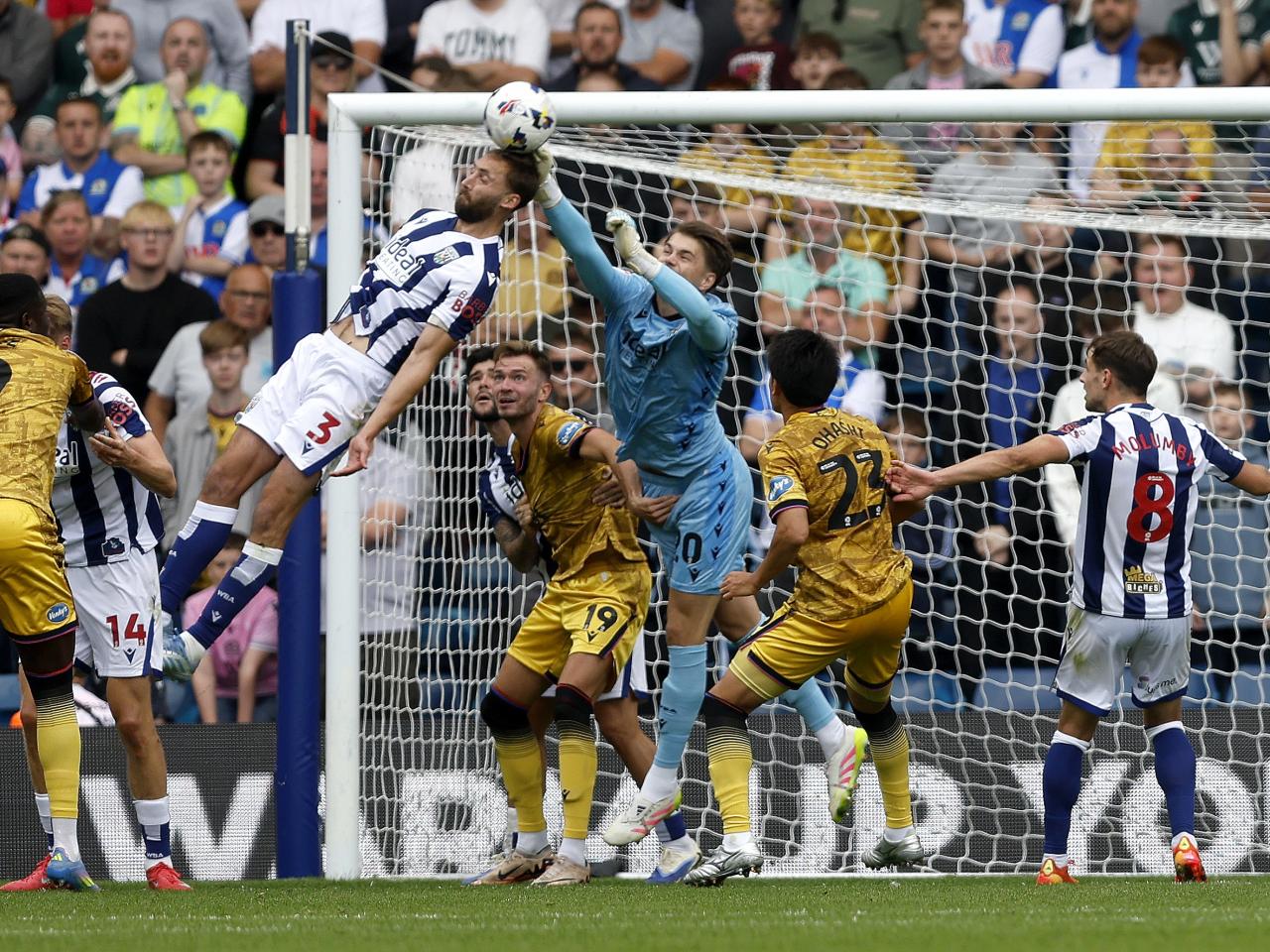 Nat Phillips trying to head the ball and Josh Griffiths trying to punch it away against Blackburn
