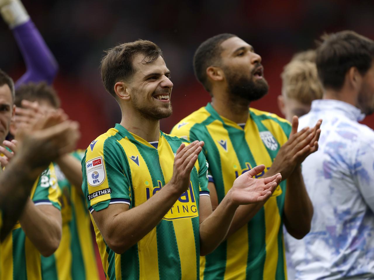 Jayson Molumby and George Campbell applauding WBA fans at Stoke