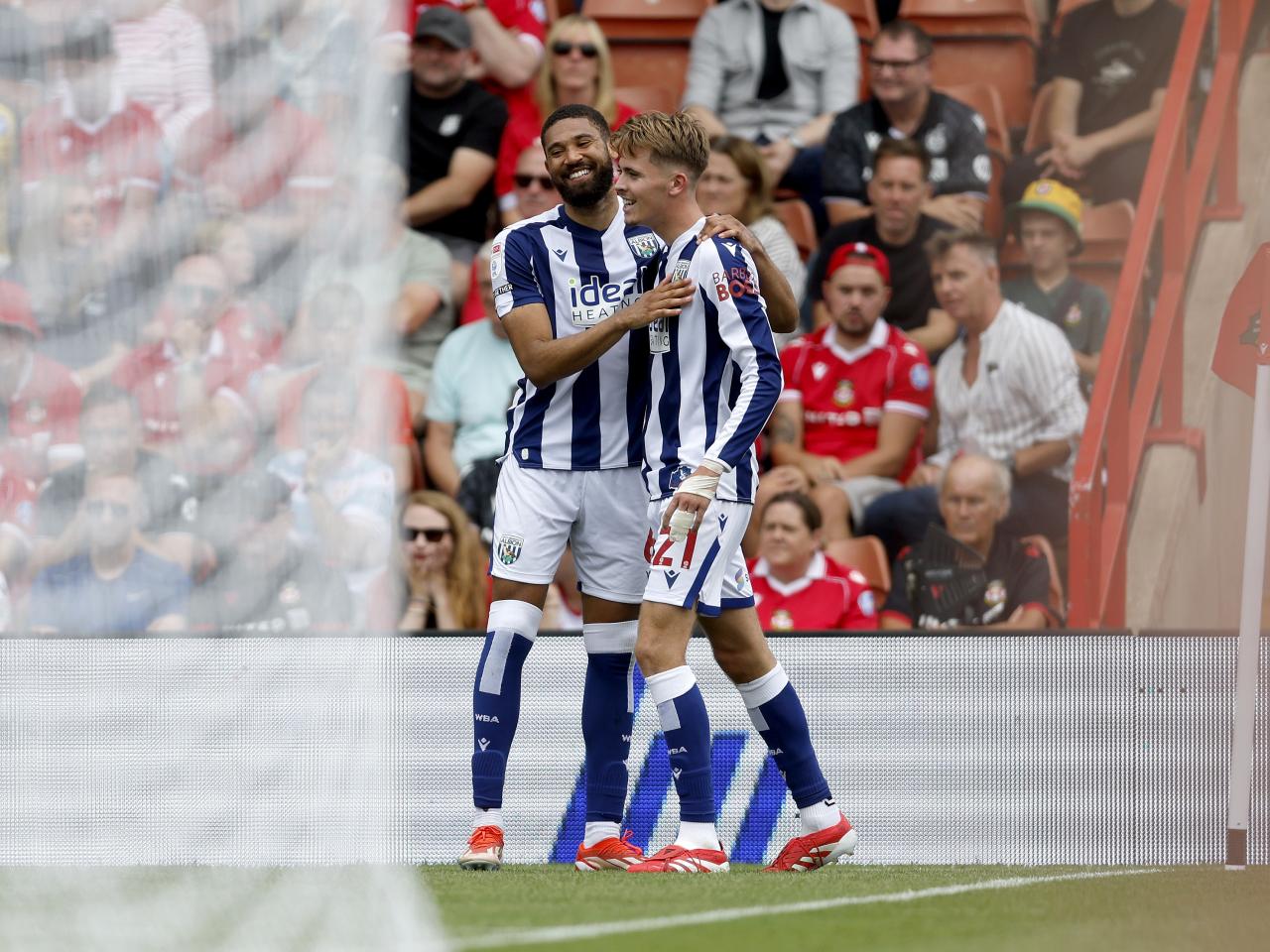 Isaac Price celebrates scoring a header against Wrexham with George Campbell