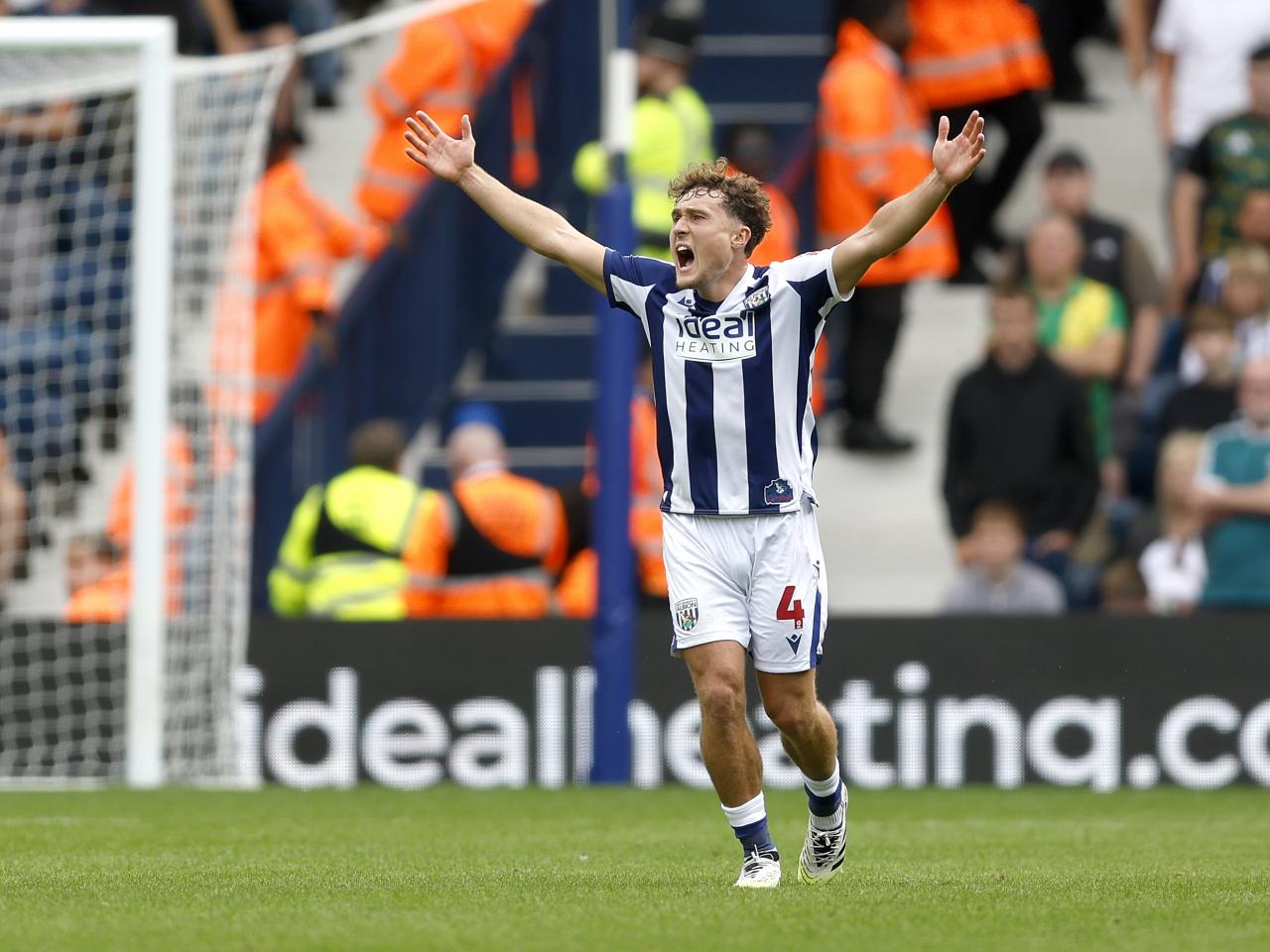 Callum Styles with his arms up against Blackburn
