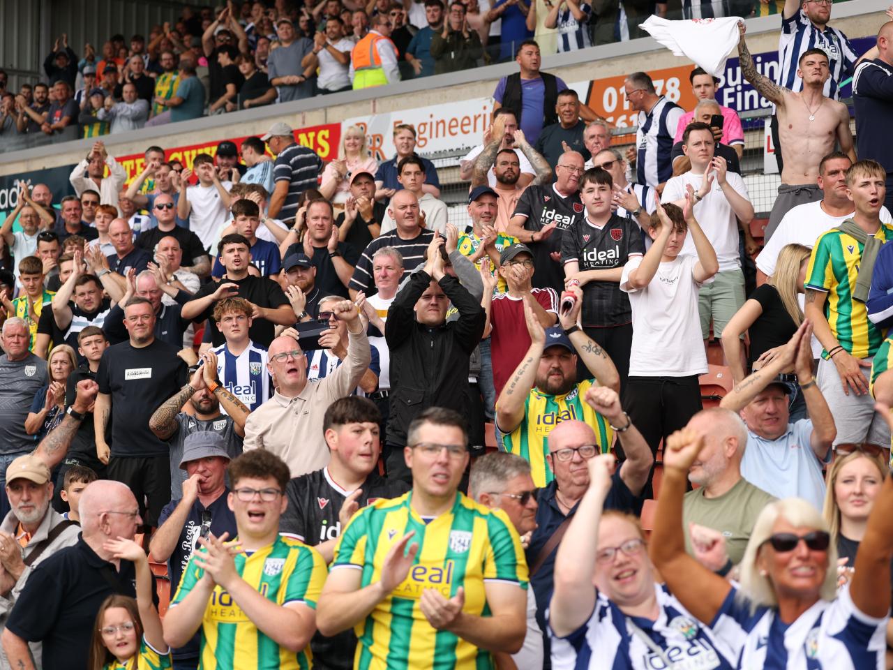 Albion fans applauding in the away end at Wrexham