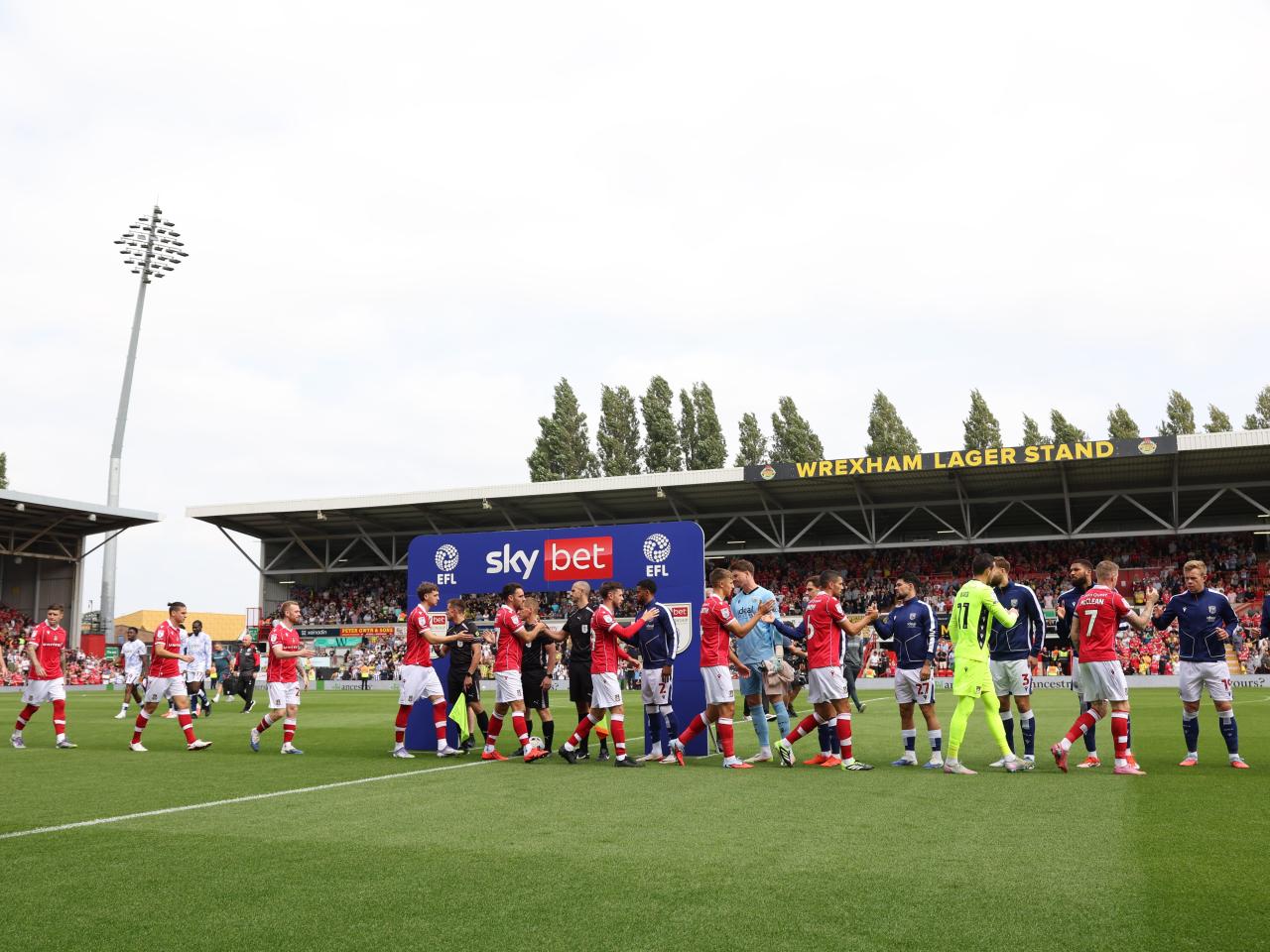 Wrexham and Albion teams shake hands before the game 