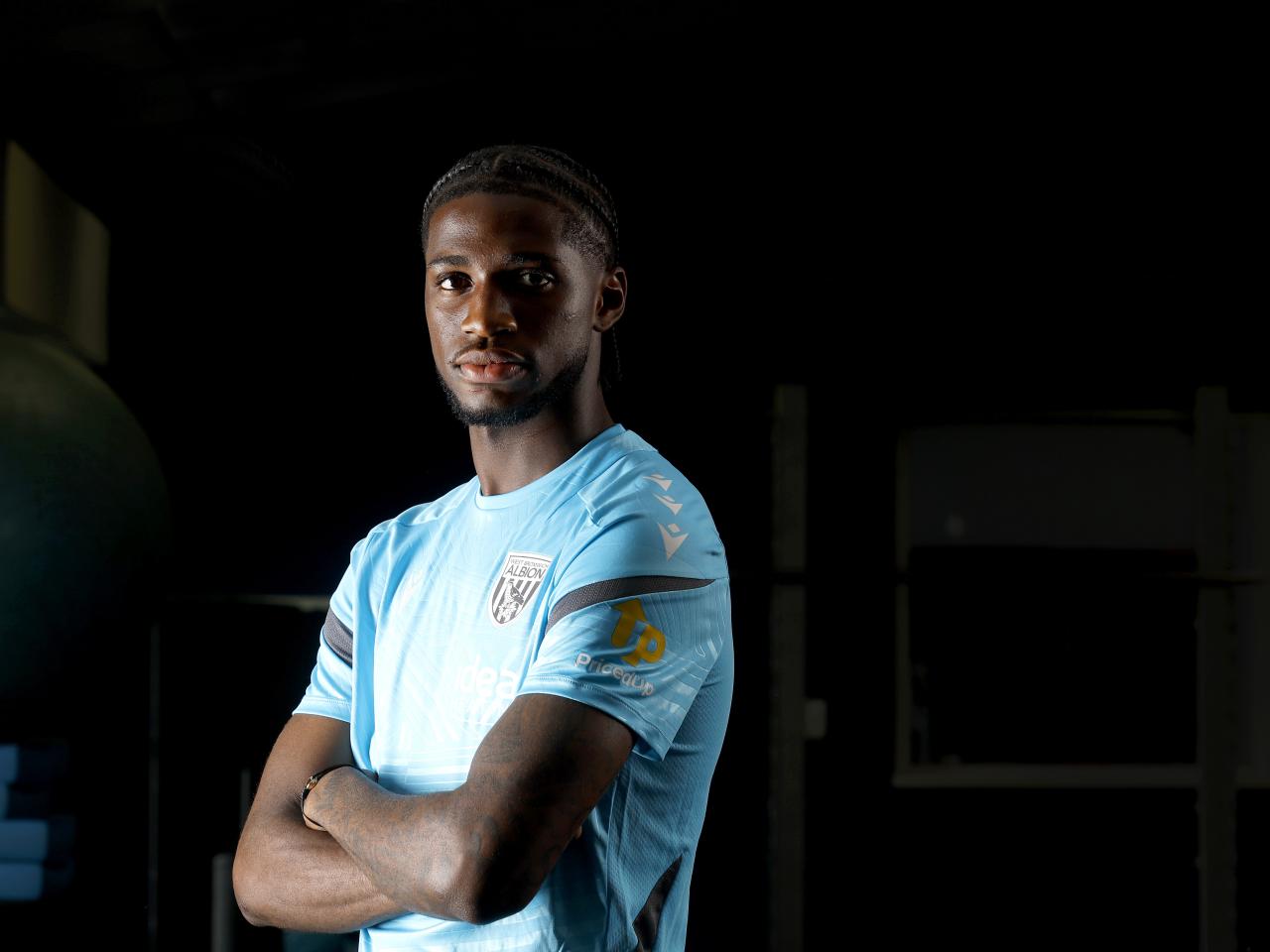 Samuel Iling-Junior looking at the camera with his arms crossed