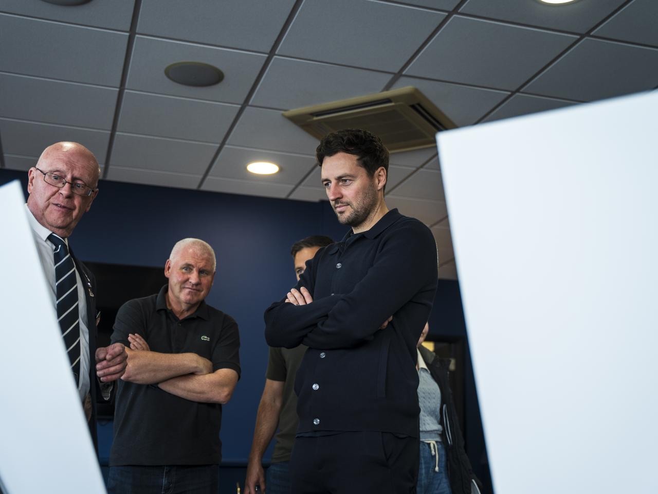Ryan Mason looking at all the memorabilia and a specially curated gallery of 125 iconic Hawthorns images