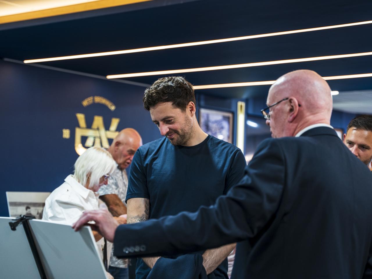 Ryan Mason walking through the East Stand looking at all the memorabilia and a specially curated gallery of 125 iconic Hawthorns images