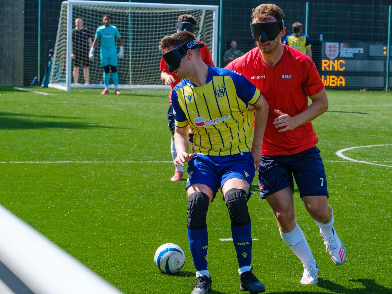 Toby Addison shields the ball from an RNC player.