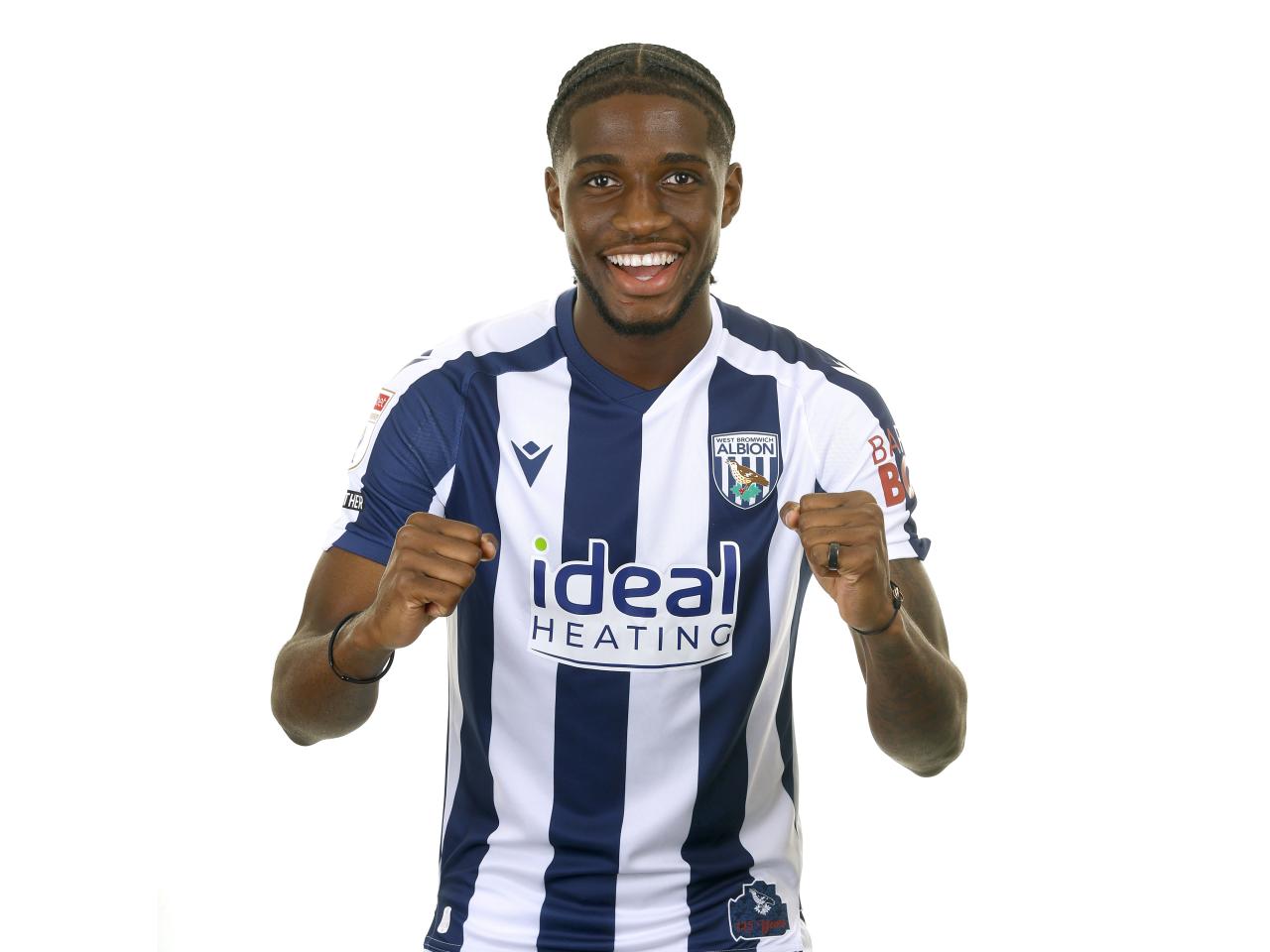 Samuel Iling-Junior posing for a photo in the home kit in front of a white background