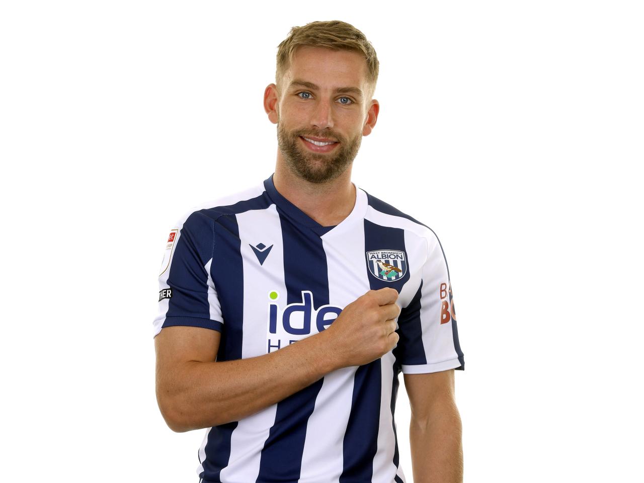 Charlie Taylor posing for a photo in the home kit in front of a white background 