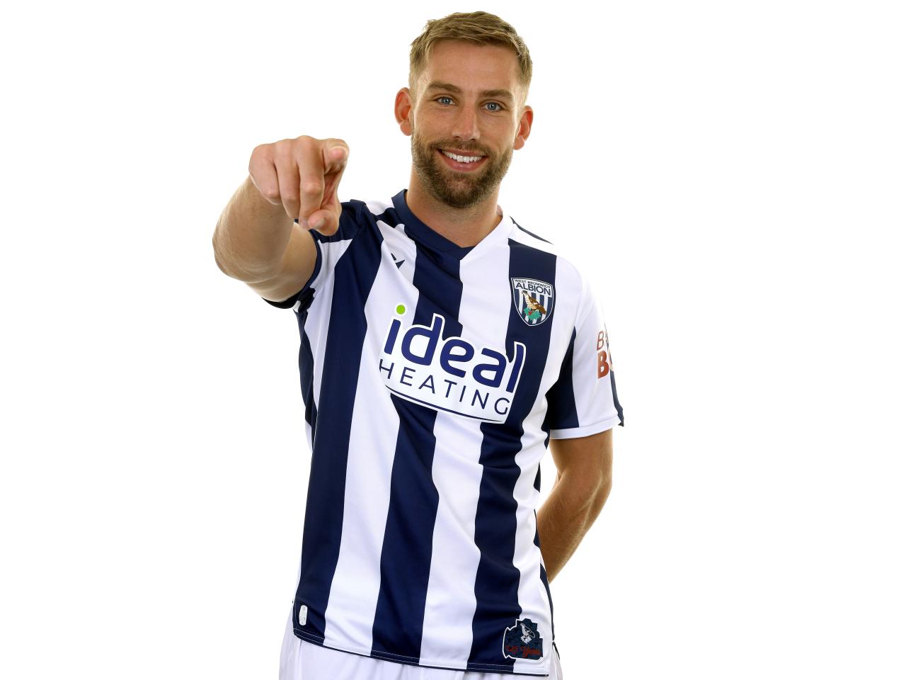 Charlie Taylor posing for a photo in the home kit in front of a white background 