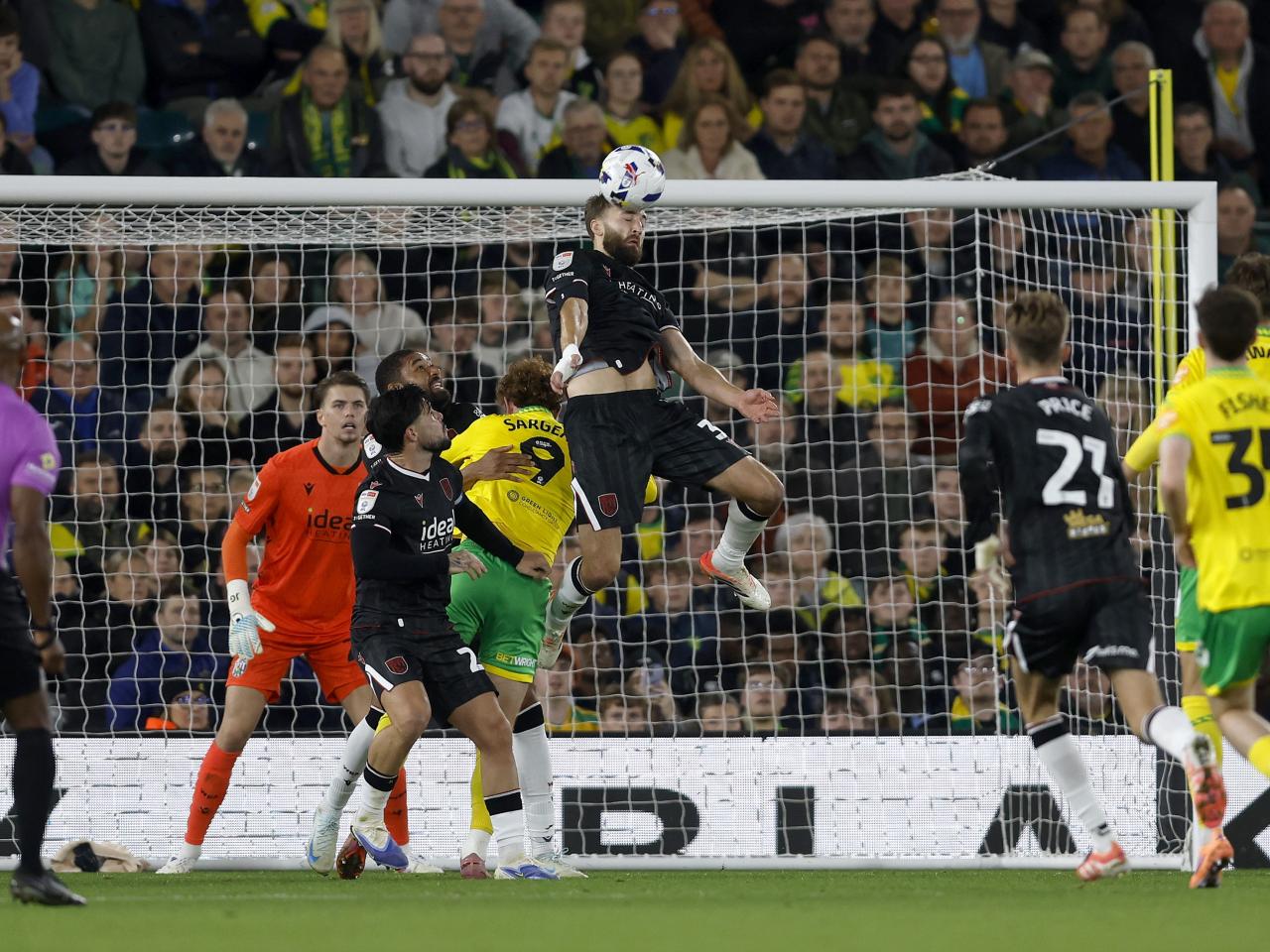Nat Phillips jumping to head the ball against Norwich City