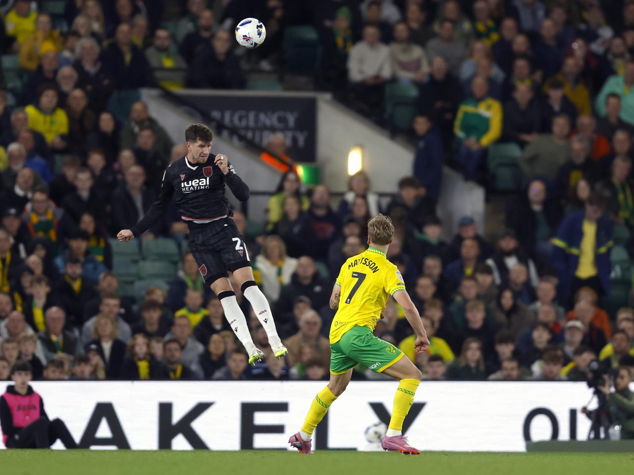 Chris Mepham jumping to head the ball against Norwich 