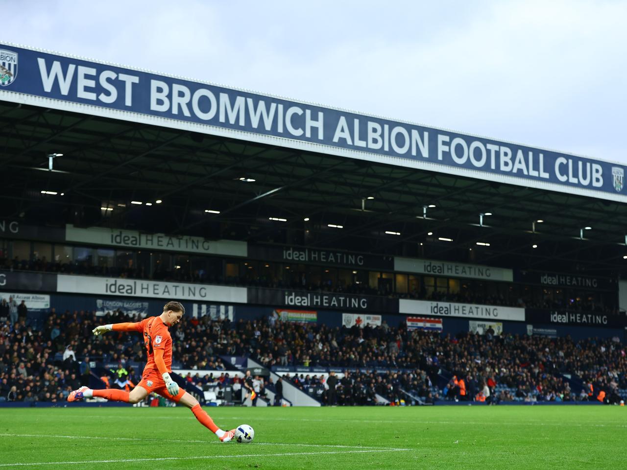 Josh Griffiths in action against PNE with the Halfords Lane stand in the background 