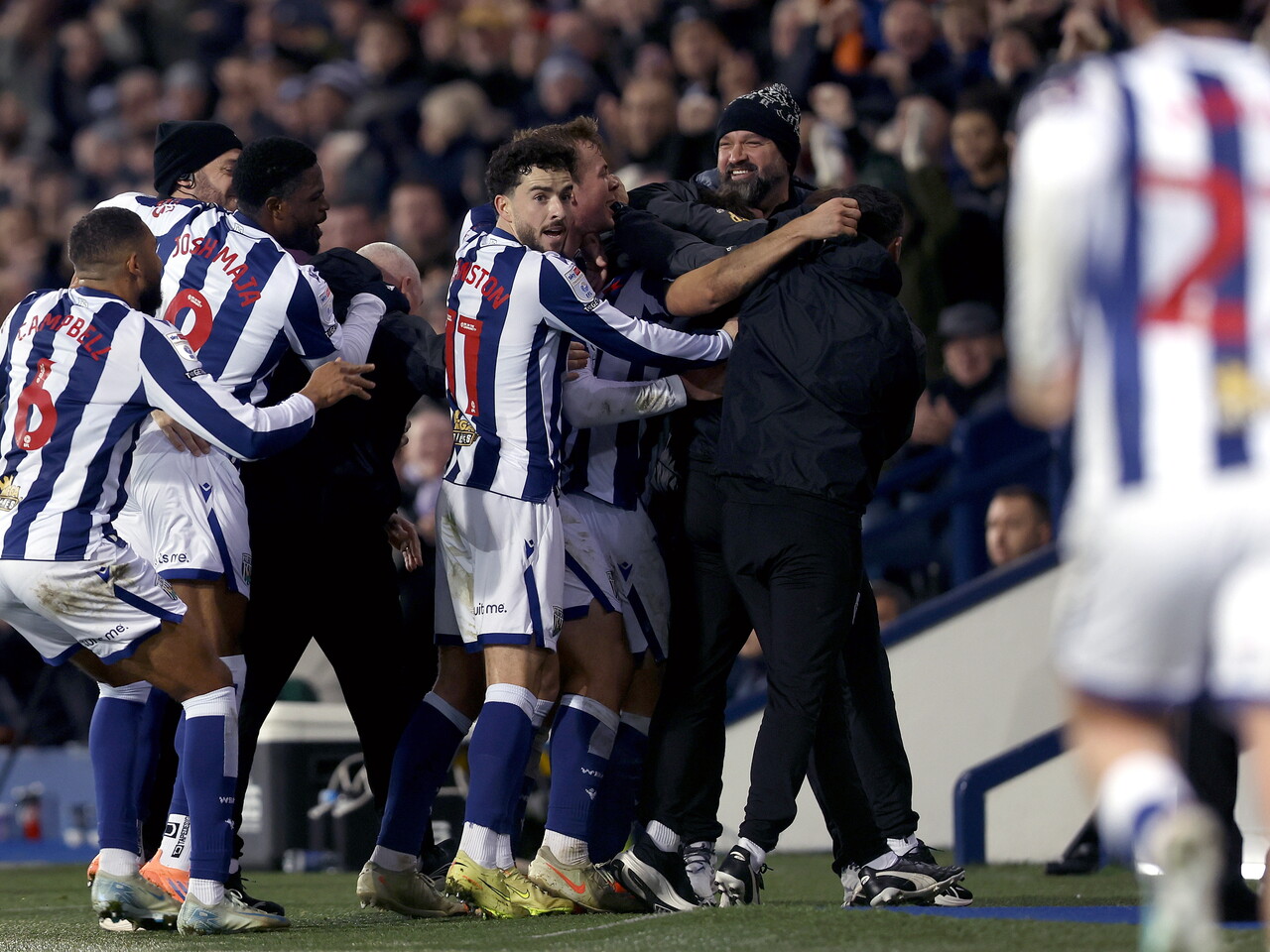 Albion players and staff celebrate Jayson Molumby's goal against Swansea