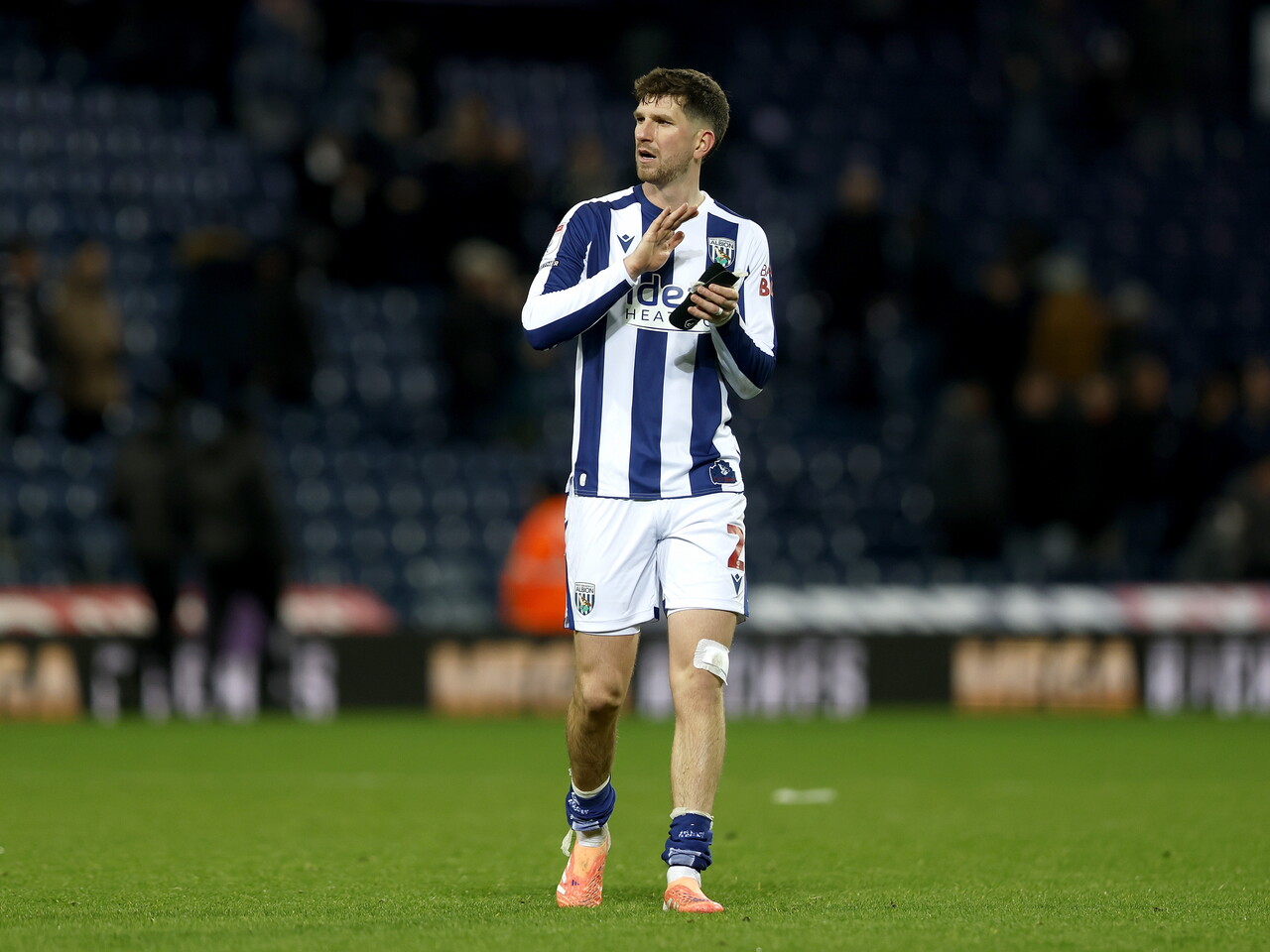 Chris Mepham applauds WBA fans after the Swansea game