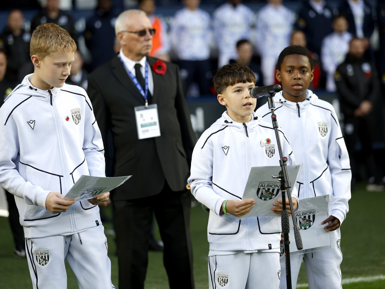 U12 academy players delivering a reading on the side of the pitch at The Hawthorns 