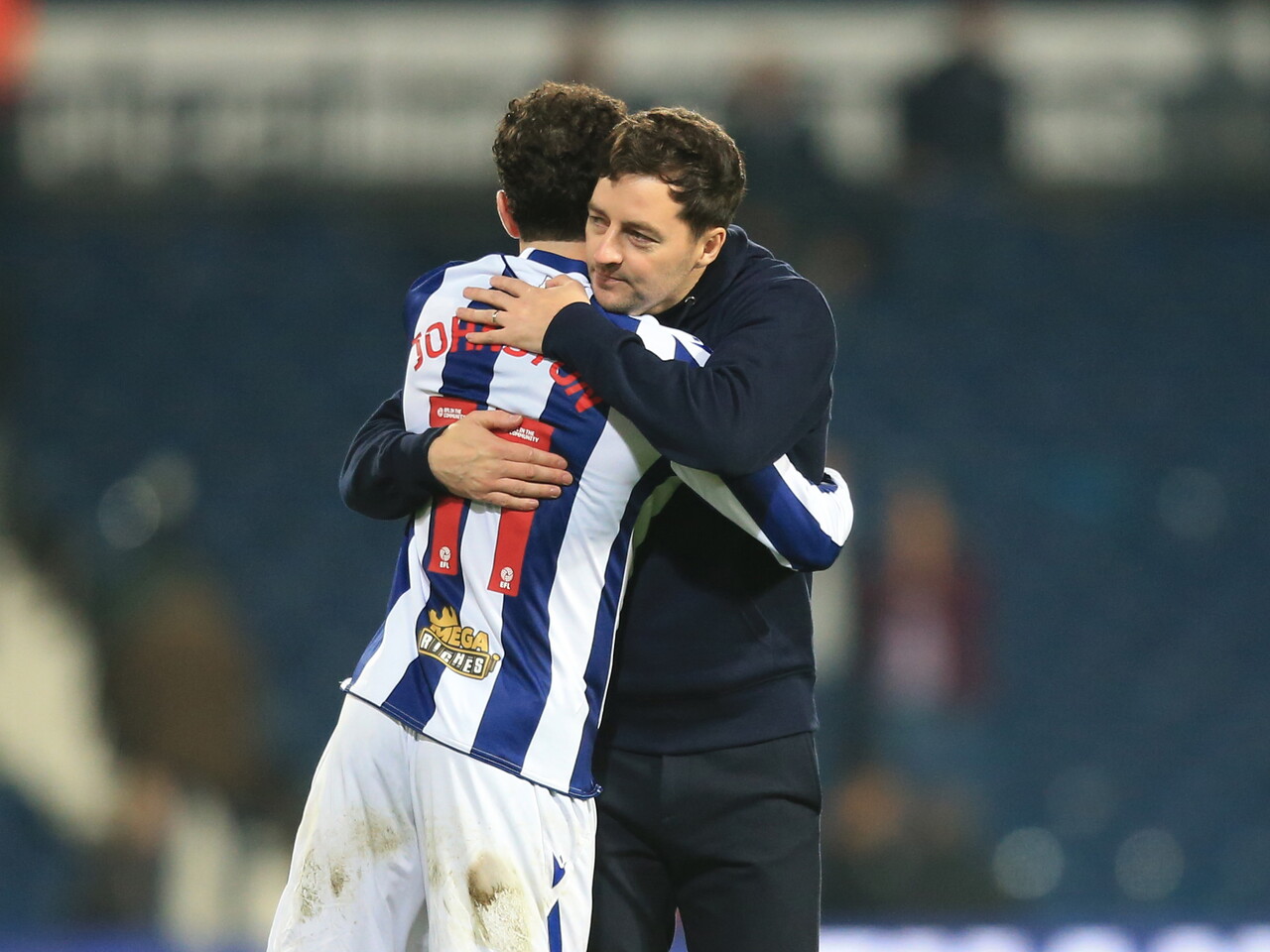 Mikey Johnston and Ryan Mason hug after beating Oxford 