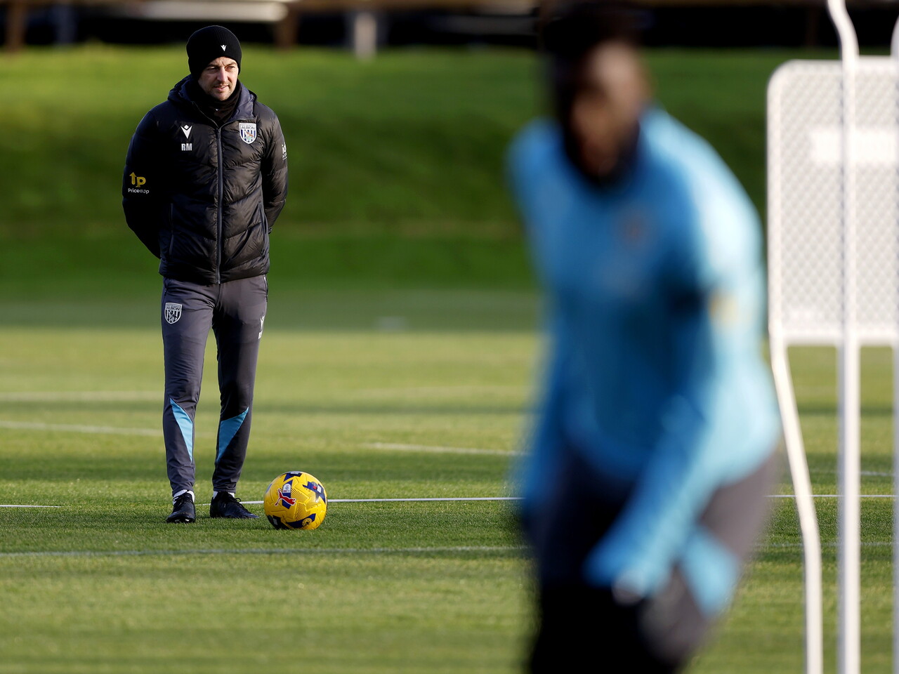 Ryan Mason watching training with a hat on