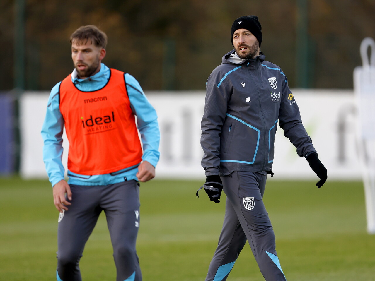 Damia Abella watching training with a hat on with Charlie Taylor stood next to him