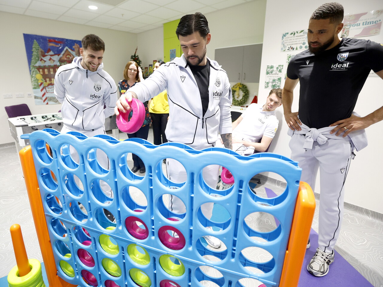 Jayson Molumby, Alex Mowatt and George Campbell playing connect four on a ward at the Midlands Met hospital