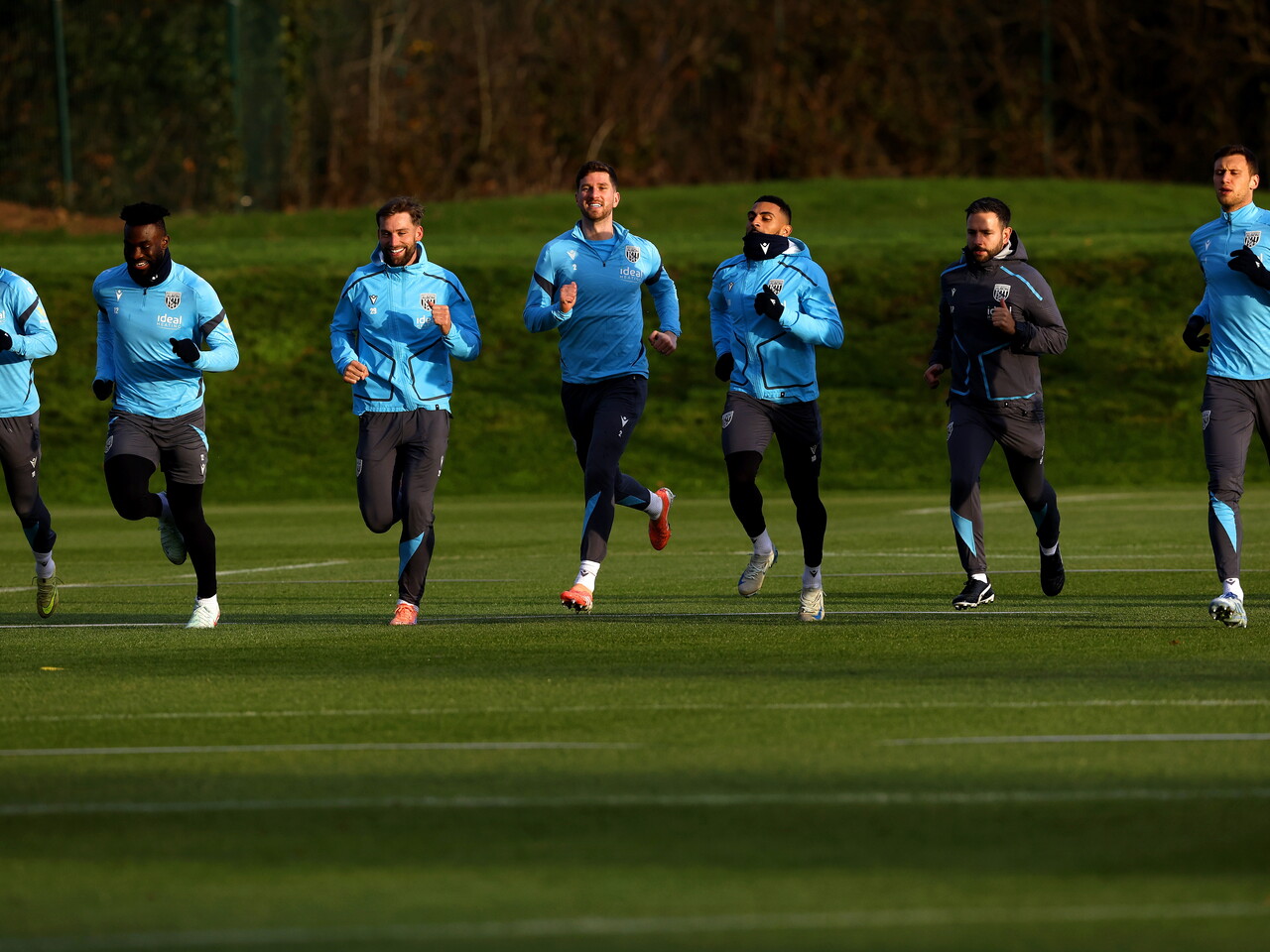 Several players running in a line during training