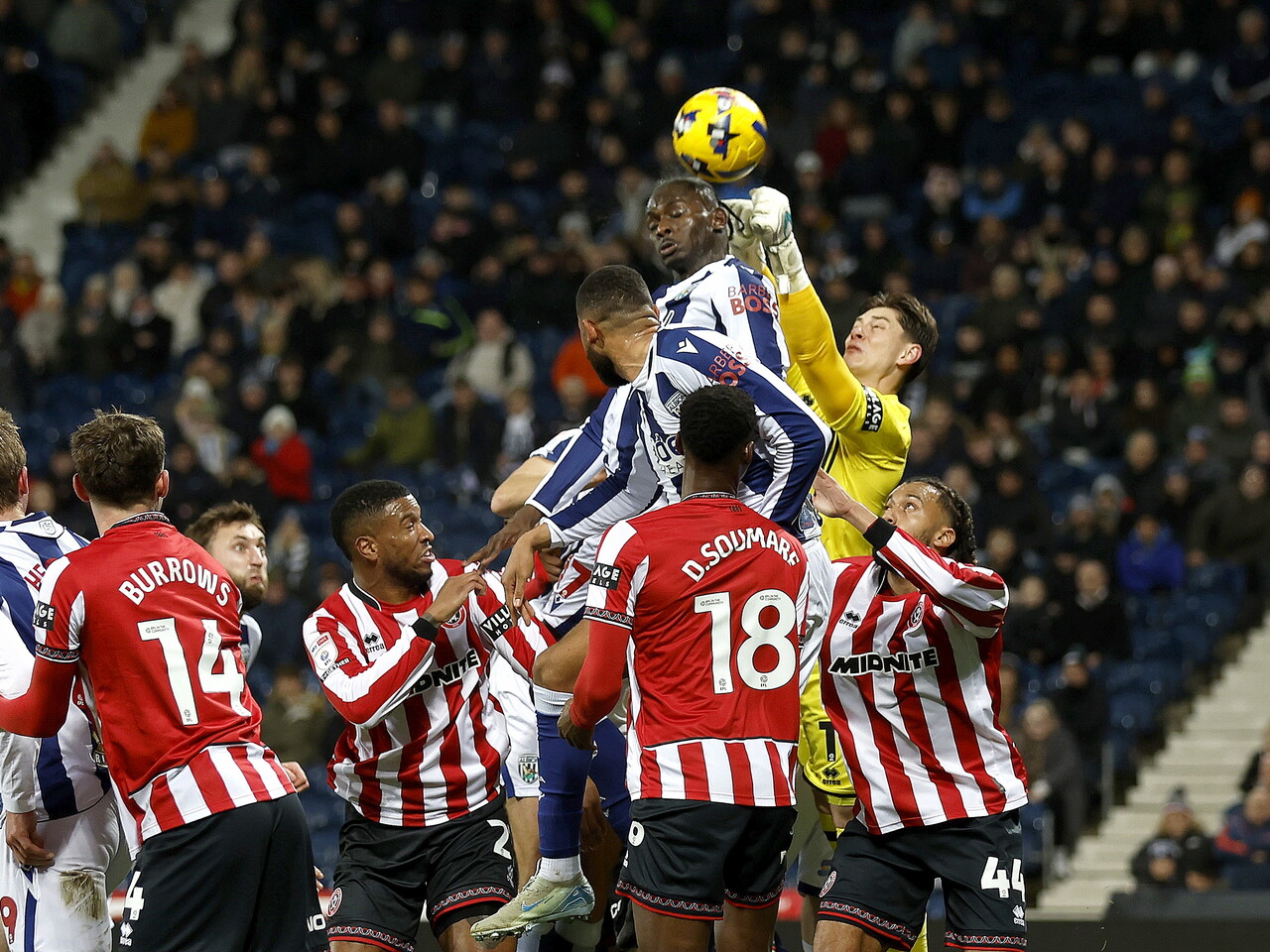 Several players jumping to try and win the ball in the air