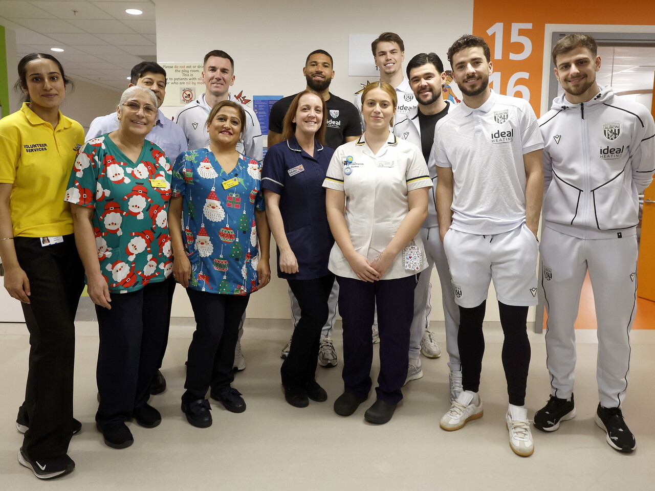 WBA players posing for a photo with NHS staff members on a ward at the Midlands Met hospital