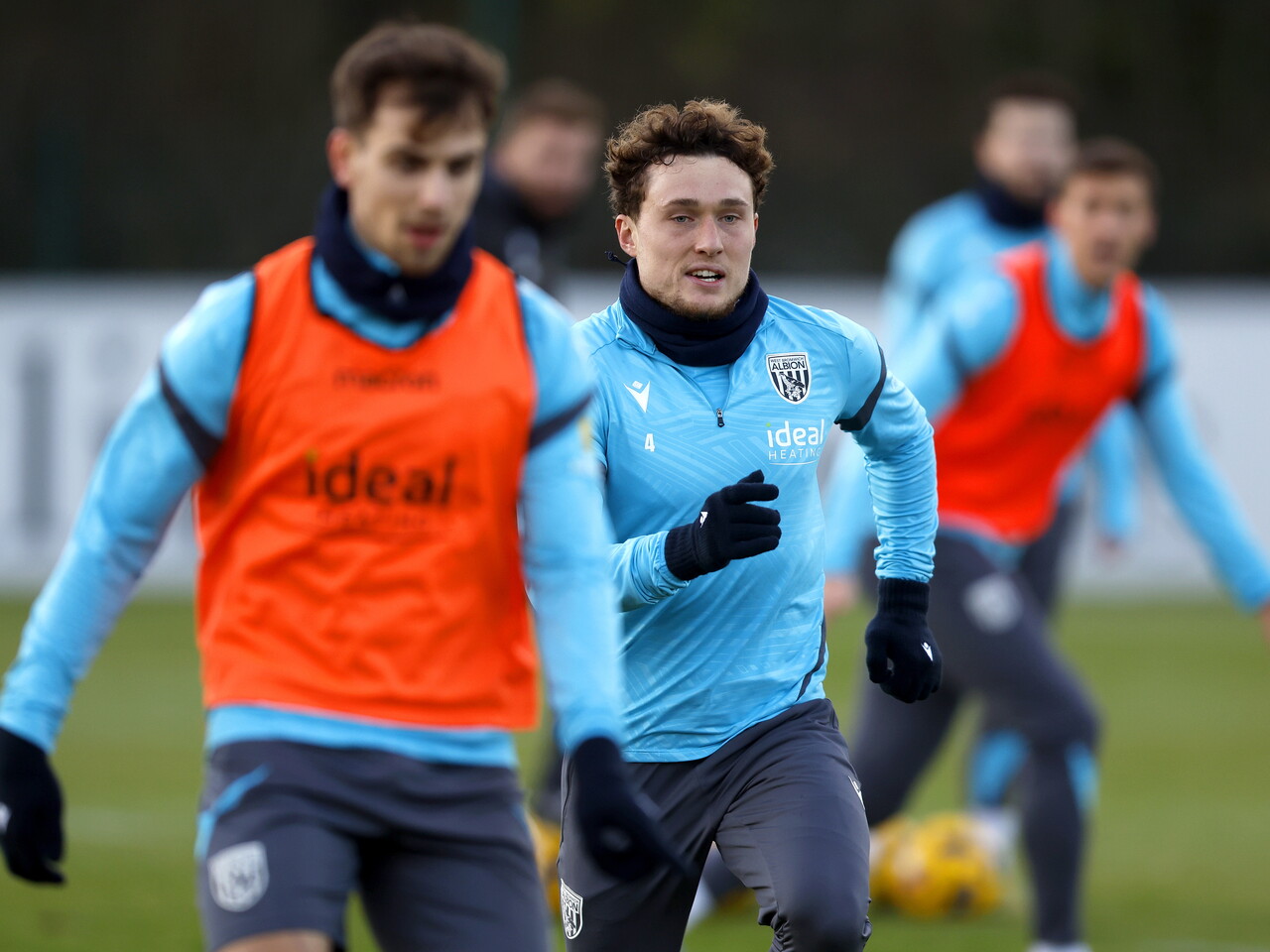 Jayson Molumby and Callum Styles battling for the ball during training