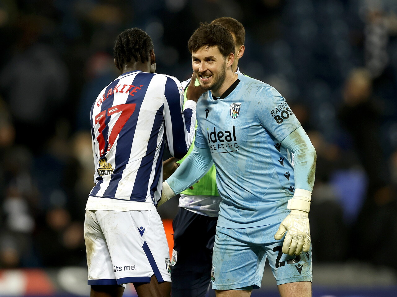 Joe Wildsmith and Ousmane Diakité embrace after beating QPR 